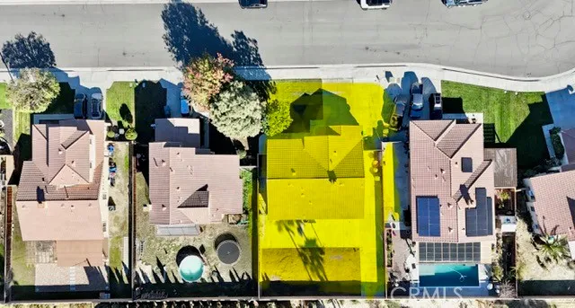 an aerial view of residential houses with outdoor space and swimming pool