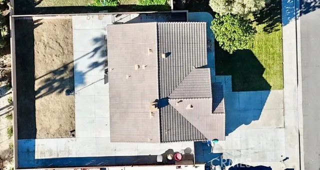 a view of an empty room with a fireplace and a window