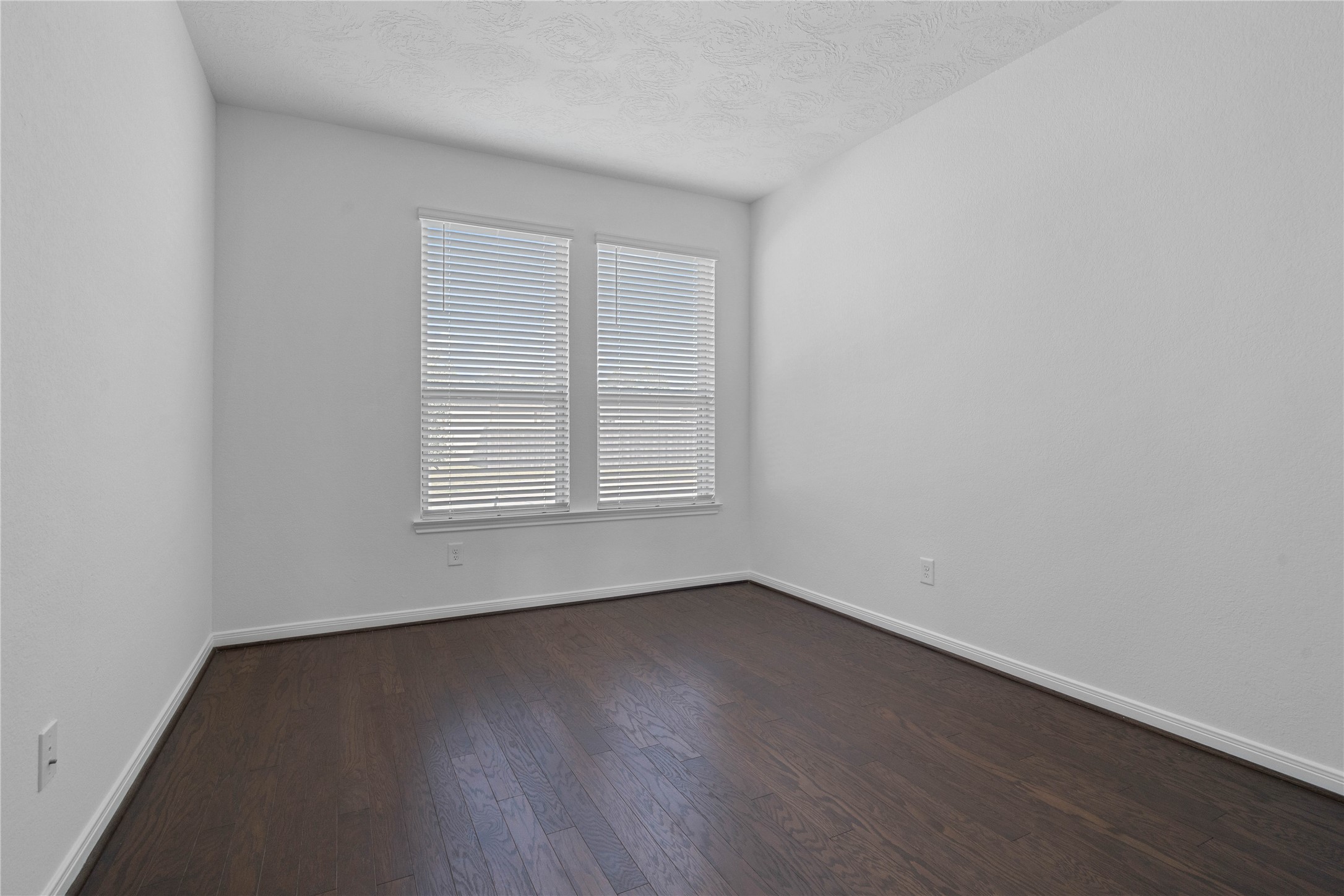 25503 Alpine Switchback Drive Spring, TX 77373 - Photo 5 of 32 Quietly nestled in front of the home is the handsome den featuring engineered wood flooring, high ceilings, large windows with privacy blinds and neutral paint.