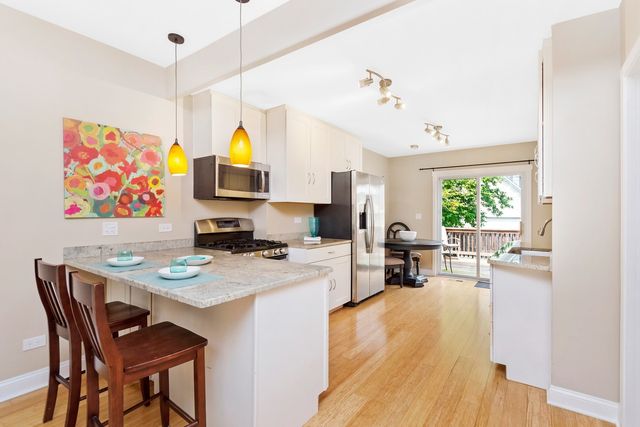 a living room with furniture a flat screen tv and a table
