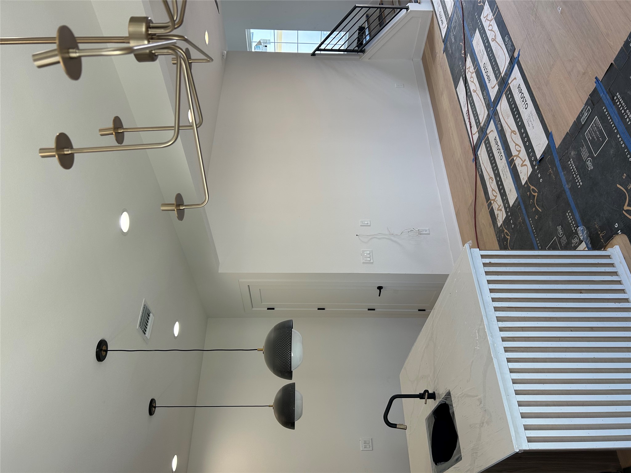 603 Vermont Road, Unit 2 Austin, TX 78702 - Photo 2 of 7 Kitchen with pendant lighting, light stone countertops, an island with sink, and light wood-style flooring