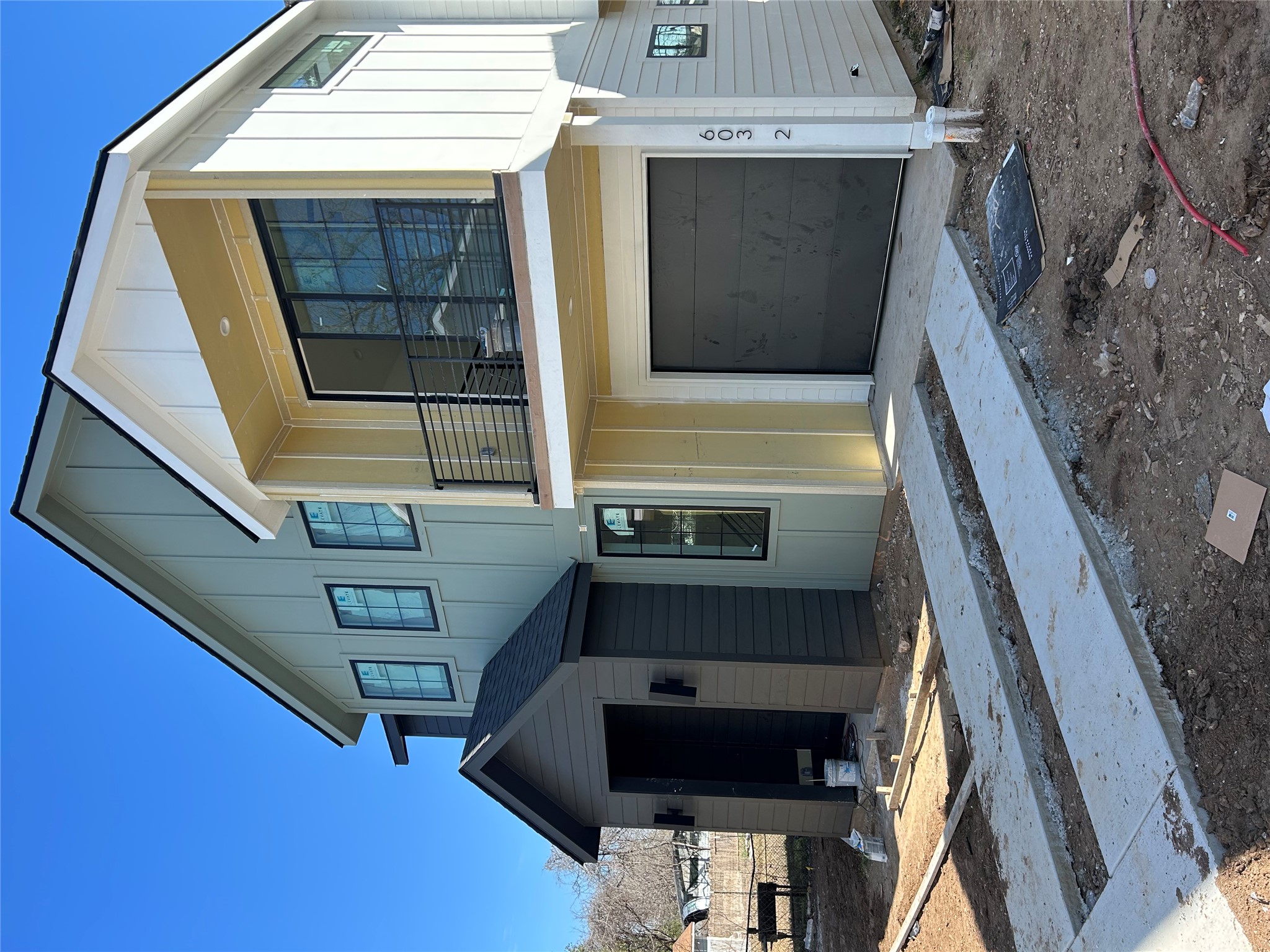 603 Vermont Road, Unit 2 Austin, TX 78702 - Photo 3 of 7 View of front of home featuring a balcony, board and batten siding, and an attached garage