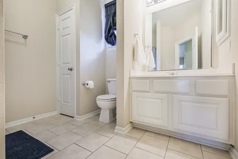 a bathroom with a toilet sink and shower