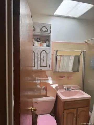a bathroom with a sink toilet and mirror