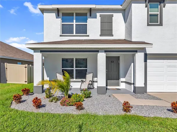 a front view of a house with outdoor seating