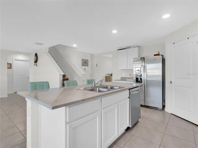 a kitchen with stainless steel appliances granite countertop a sink and a microwave