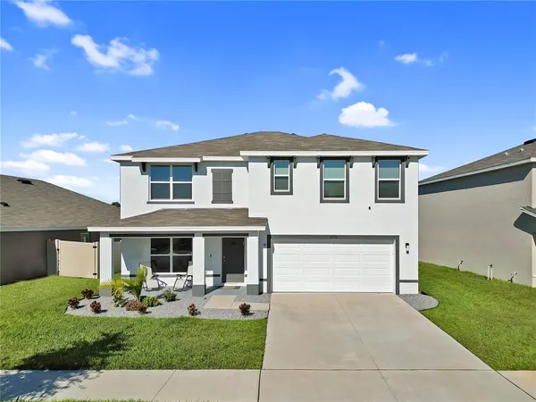 a front view of a house with a yard and garage