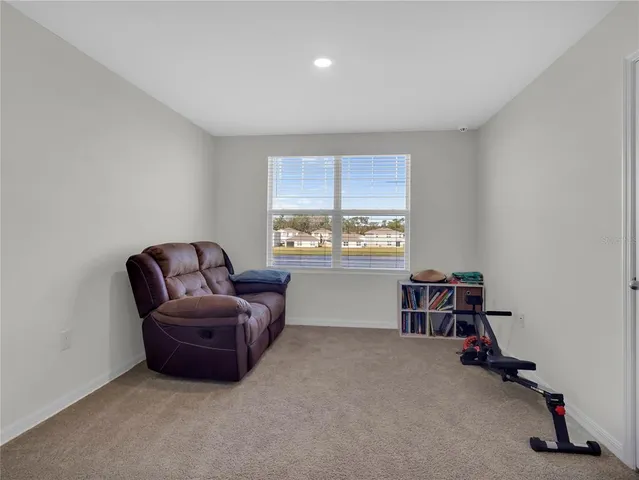 a bedroom with a bed and chair