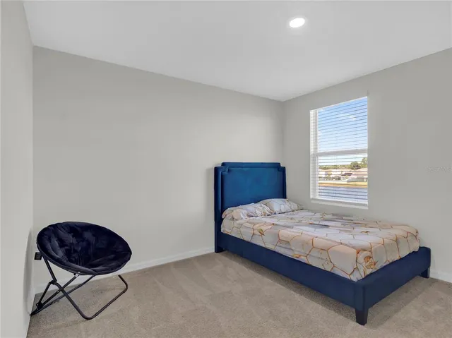 a bedroom with a bed and window