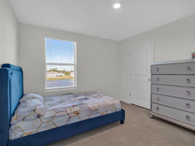 a bedroom with two beds and a window