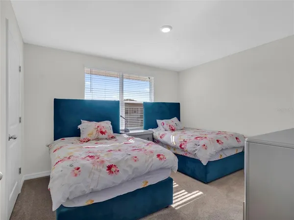 a bedroom with a bed and dresser