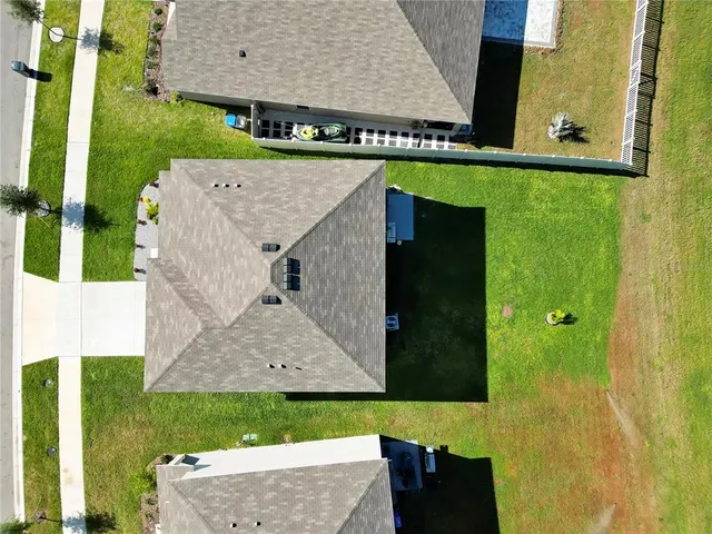 a aerial view of a house with a yard