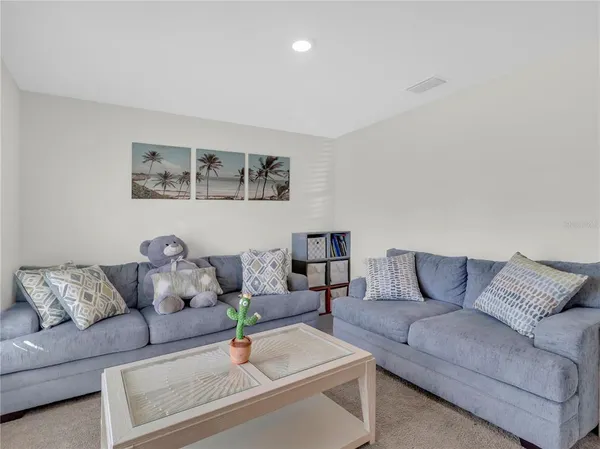 a living room with furniture and night stand