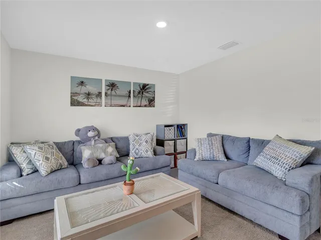 a living room with furniture and night stand