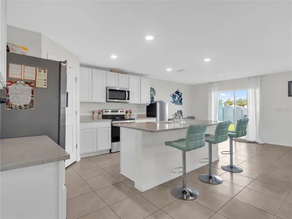 a kitchen with a sink cabinets and refrigerator