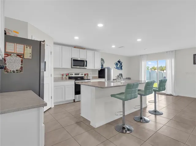 a kitchen with a sink cabinets and refrigerator