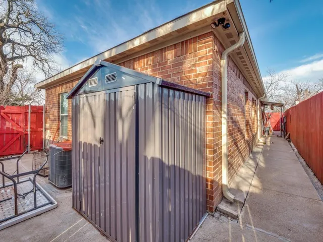 a view of wooden house with a small yard