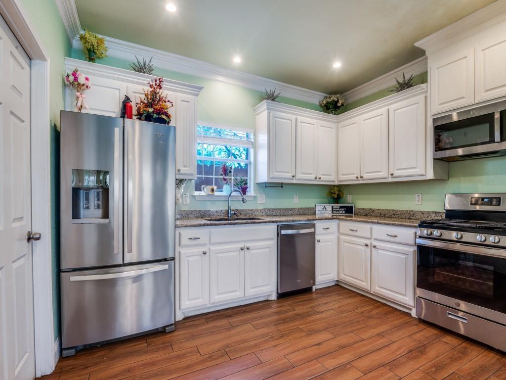 2410 Carleta Street Dallas, TX 75253 - Photo 6 of 20 a kitchen with granite countertop stainless steel appliances a refrigerator and a stove top oven