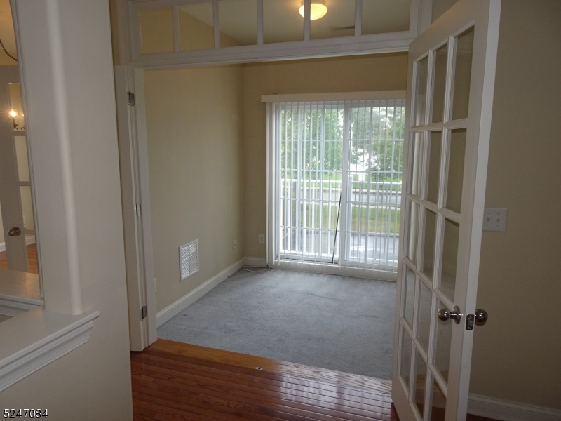 112 Limerick Lane, Unit 1 Phillipsburg, NJ 08865 - Photo 11 of 41 a view of an empty room with wooden floor and a window
