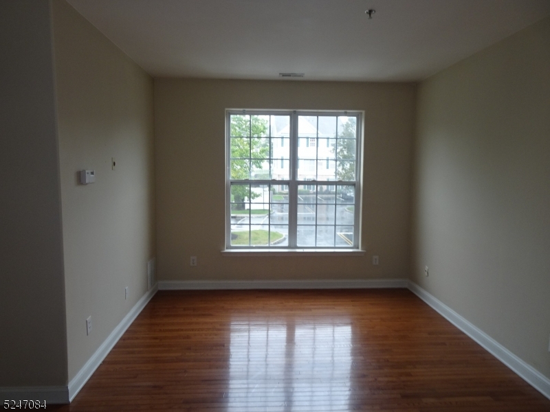112 Limerick Lane, Unit 1 Phillipsburg, NJ 08865 - Photo 3 of 41 an empty room with wooden floor and windows