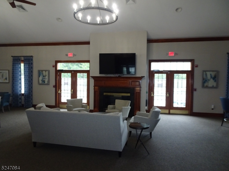 112 Limerick Lane, Unit 1 Phillipsburg, NJ 08865 - Photo 34 of 41 a living room with furniture a fireplace and a flat screen tv