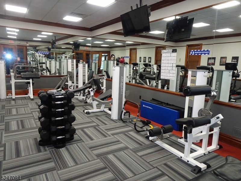 112 Limerick Lane, Unit 1 Phillipsburg, NJ 08865 - Photo 37 of 41 a room with lots of wooden furniture and a ceiling fan