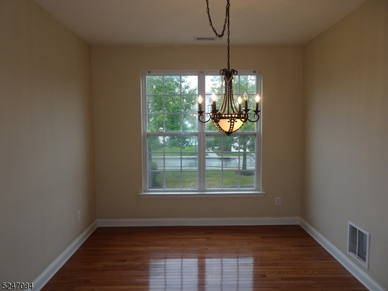 112 Limerick Lane, Unit 1 Phillipsburg, NJ 08865 - Photo 9 of 41 an empty room with wooden floor and windows