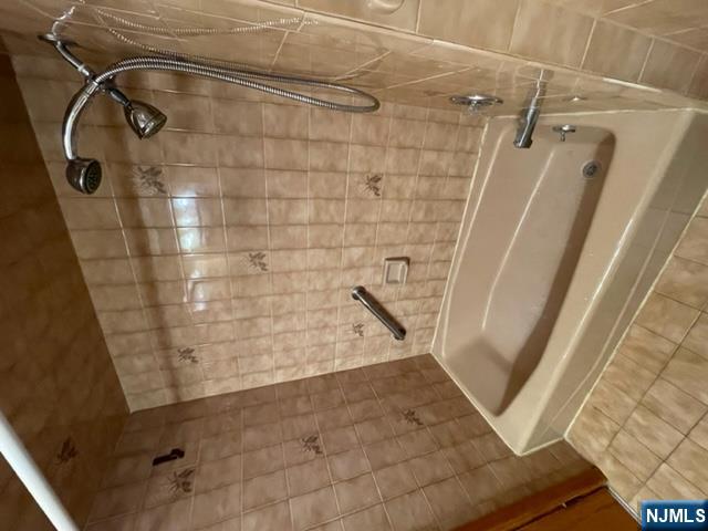 209 8th Street Fairview, NJ 07022 - Photo 12 of 41 a bathroom with a shower and a tub
