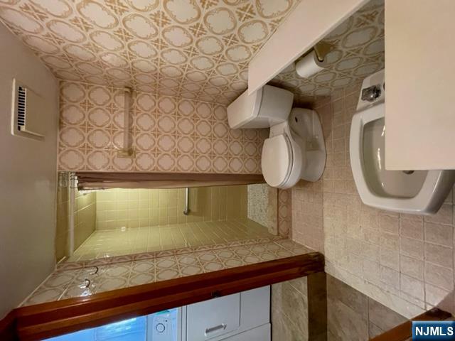 209 8th Street Fairview, NJ 07022 - Photo 17 of 41 a bathroom with a toilet and a shower