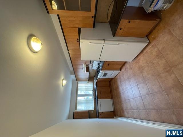 209 8th Street Fairview, NJ 07022 - Photo 20 of 41 a kitchen with refrigerator and cabinets