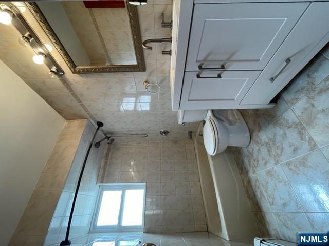 209 8th Street Fairview, NJ 07022 - Photo 33 of 41 a bathroom with a toilet sink and mirror