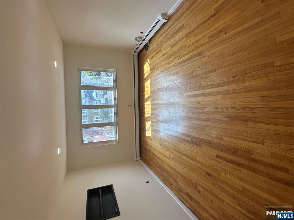 209 8th Street Fairview, NJ 07022 - Photo 36 of 41 wooden floor in an empty room with a window
