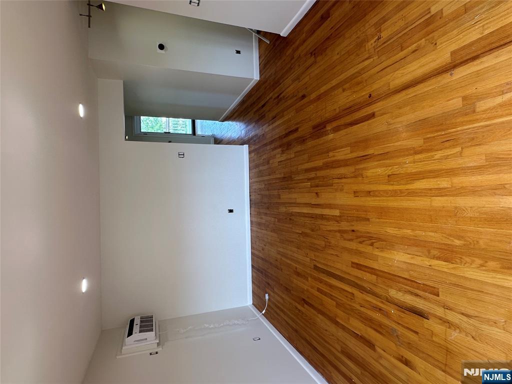 209 8th Street Fairview, NJ 07022 - Photo 37 of 41 a view of wooden floor and brick walls