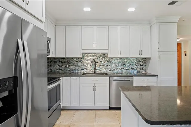 a living room with furniture a ceiling fan and a window
