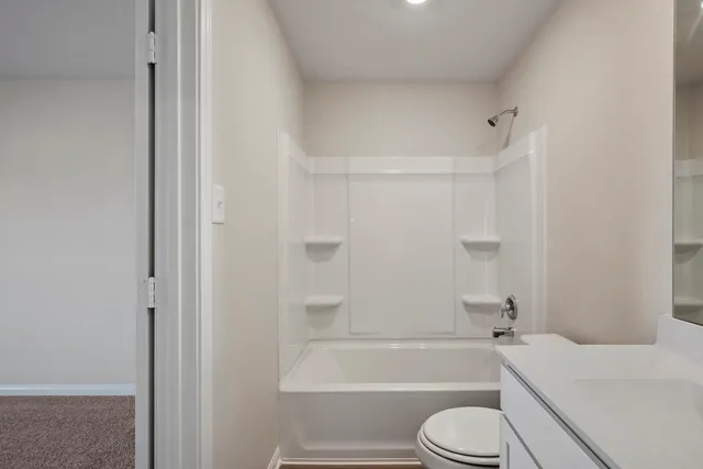 a bathroom with a toilet and a bath tub