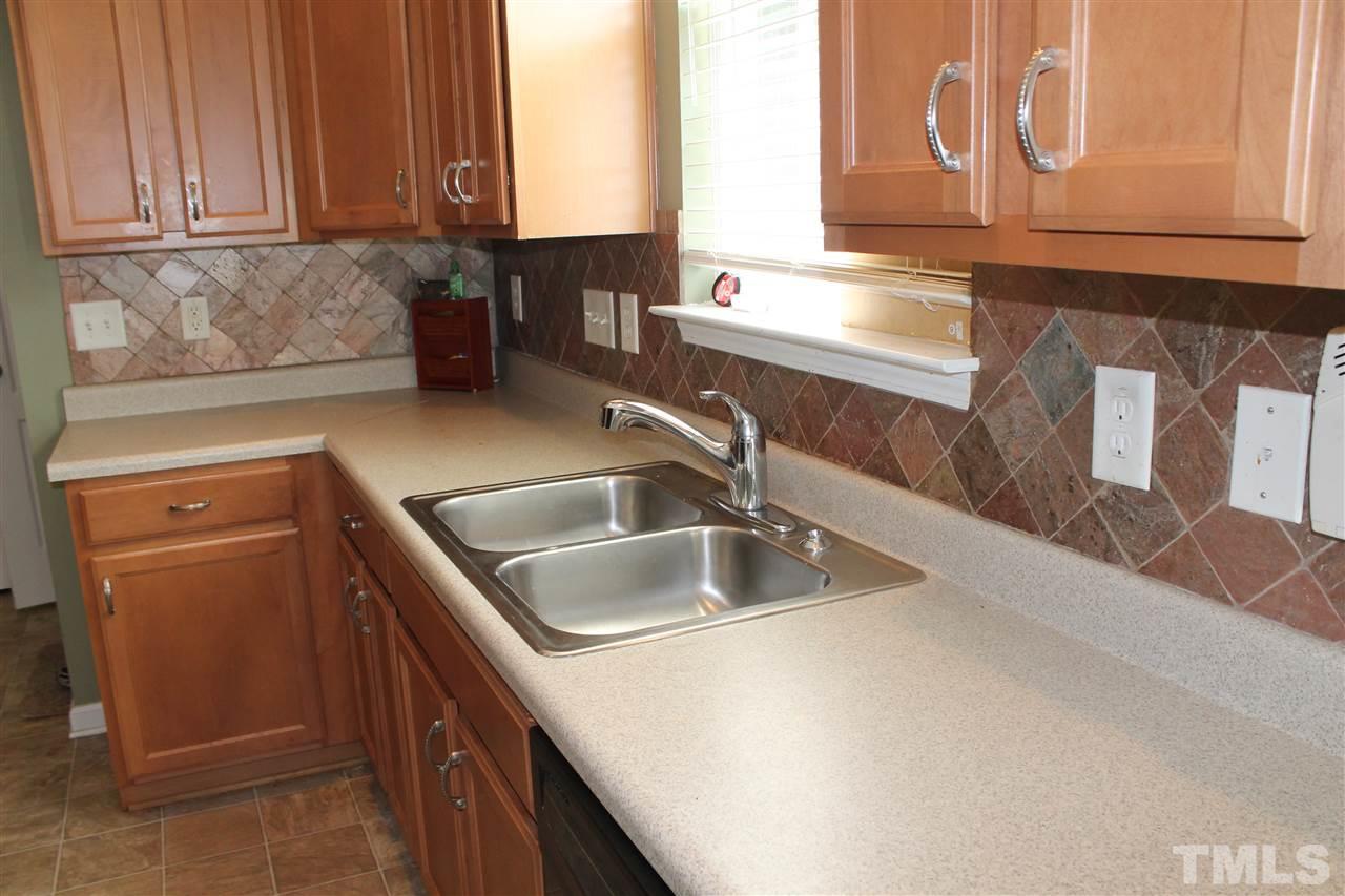 2812 Orchard Trace Way Raleigh, NC 27610 - Photo 11 of 24 This Kitchen/Eat-In has a beautiful stone back splash giving it a nice elegant touch