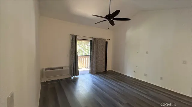 a view of storage and utility room with wooden floor