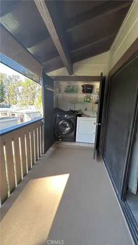 a backyard of a house with barbeque oven table and chairs