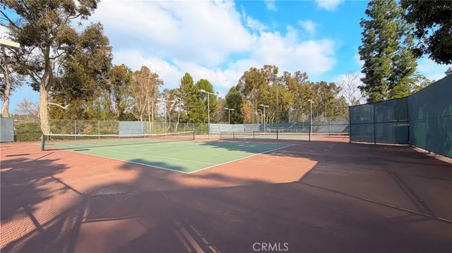 a backyard of a house with barbeque oven table and chairs