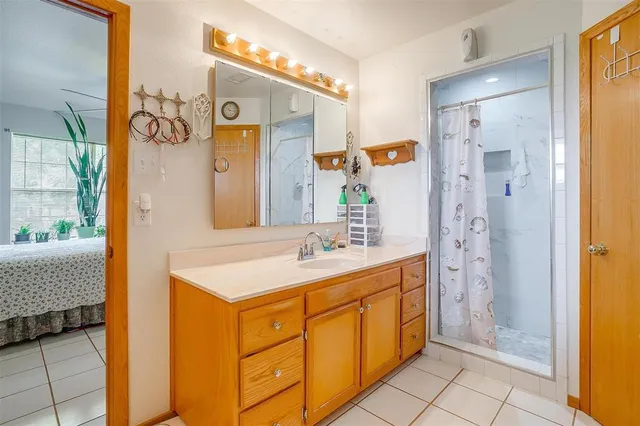 a bathroom with a sink a mirror and a shower