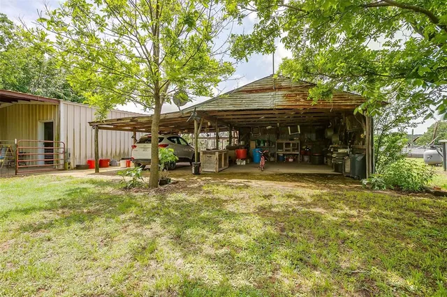 a view of a house with a wooden fence