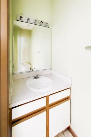 a bathroom with a double vanity sink toilet and shower