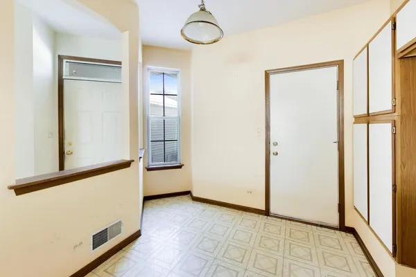 a view of an empty room with a fireplace and a window