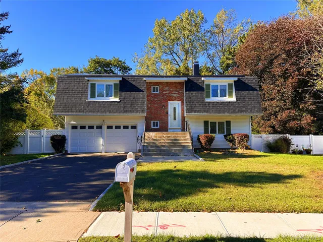 a view of a house with a yard balcony and fire pit