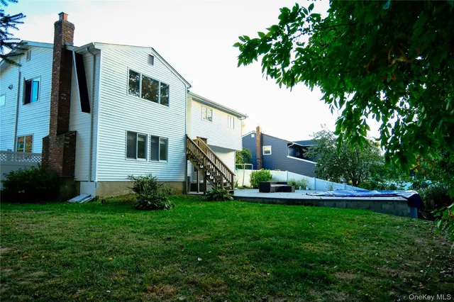 a front view of a house with a garden and trees