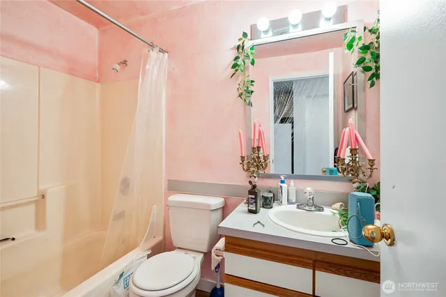 a bathroom with a sink vanity mirror and toilet