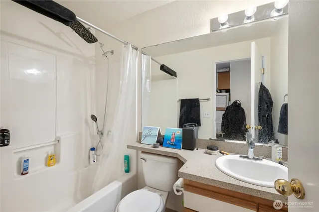 a bathroom with a sink double vanity mirror and toilet