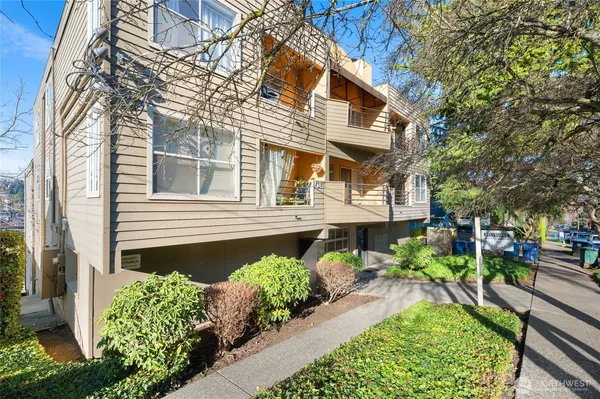 a front view of a house with a yard and outdoor seating