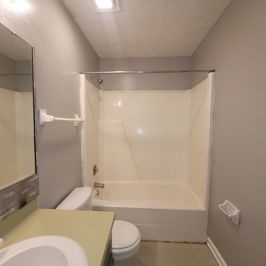 508 23rd Street, Unit A Phenix City, AL 36867 - Photo 13 of 14 a bathroom with a granite countertop bathtub shower sink vanity and toilet