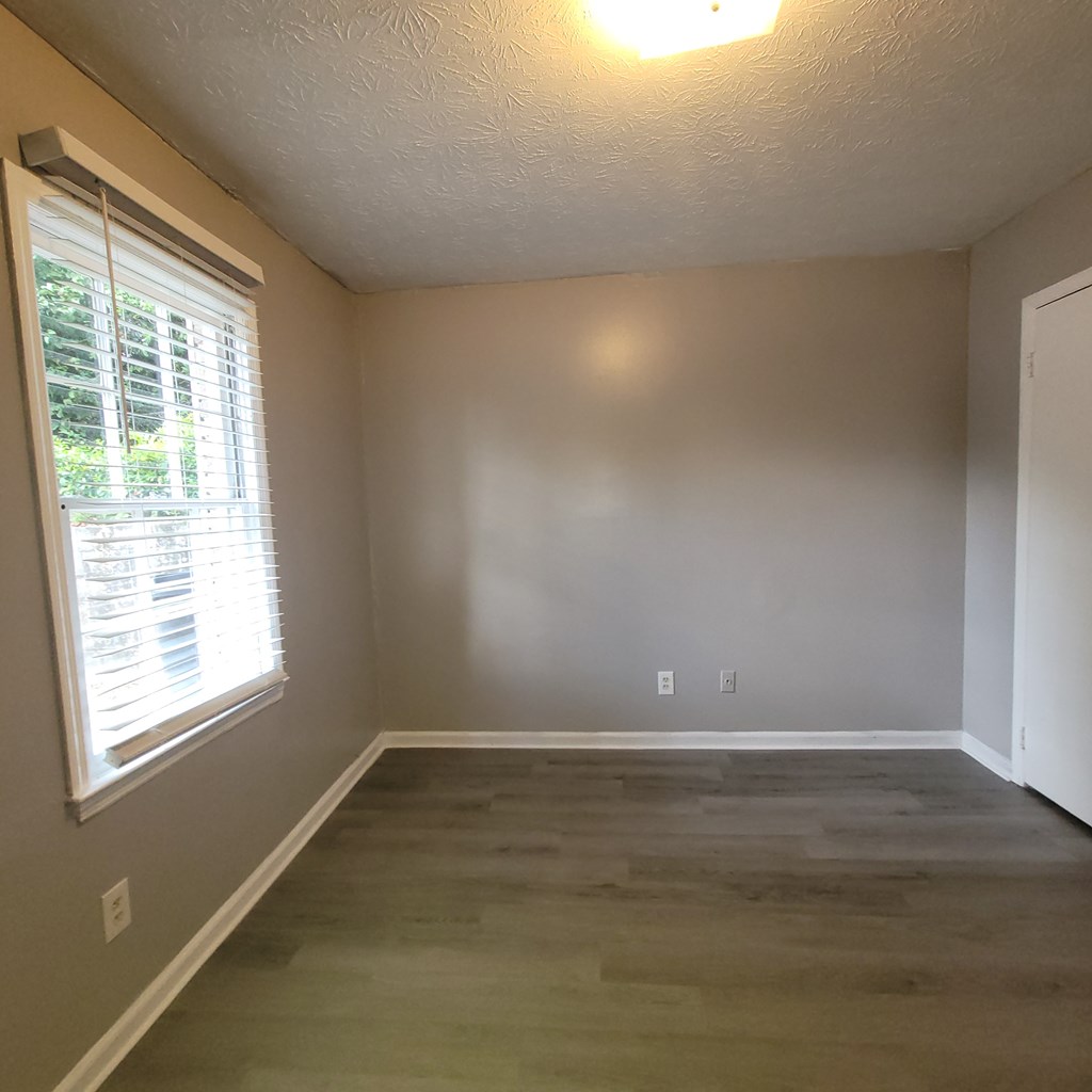 508 23rd Street, Unit A Phenix City, AL 36867 - Photo 10 of 14 a view of an empty room with wooden floor and a window